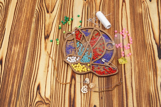 Needles and colorful threads on table